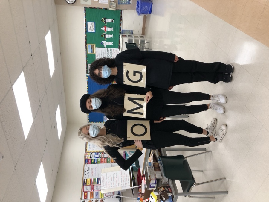 Danielle and two colleagues in matching Halloween costumes in a classroom